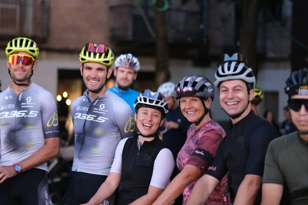 Group of cyclists gathered at the start of the Q36.5 Pro Cycling Team social ride in Girona.