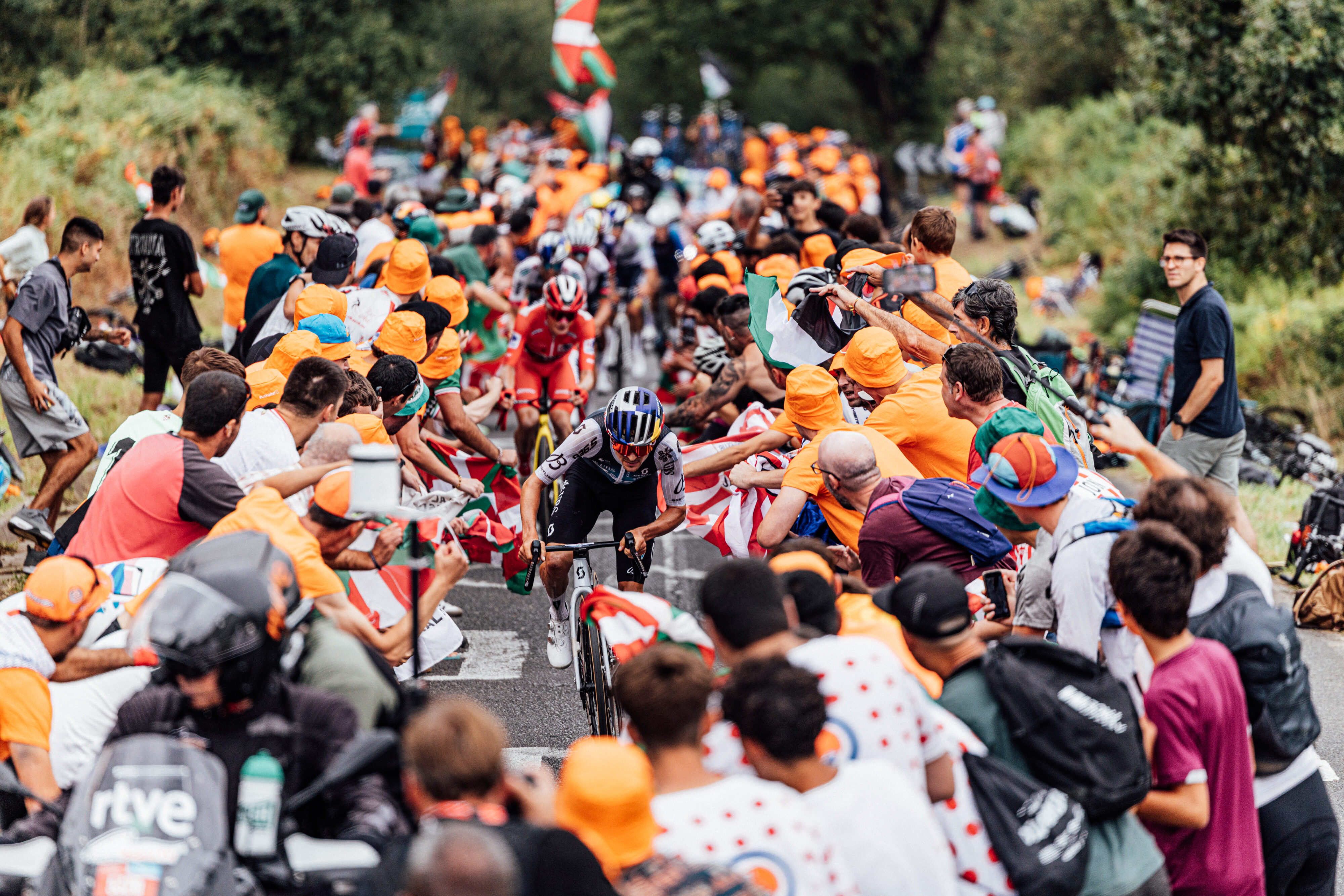 Tom Pidcock of Q36.5 Pro Cycling Team climbs through packed crowds at La Vuelta 2025